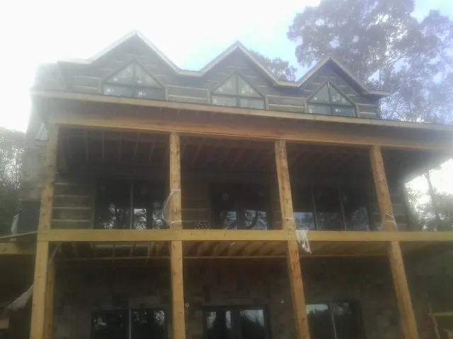 Dormers and porch framing on a large log home under construction in Newmarket